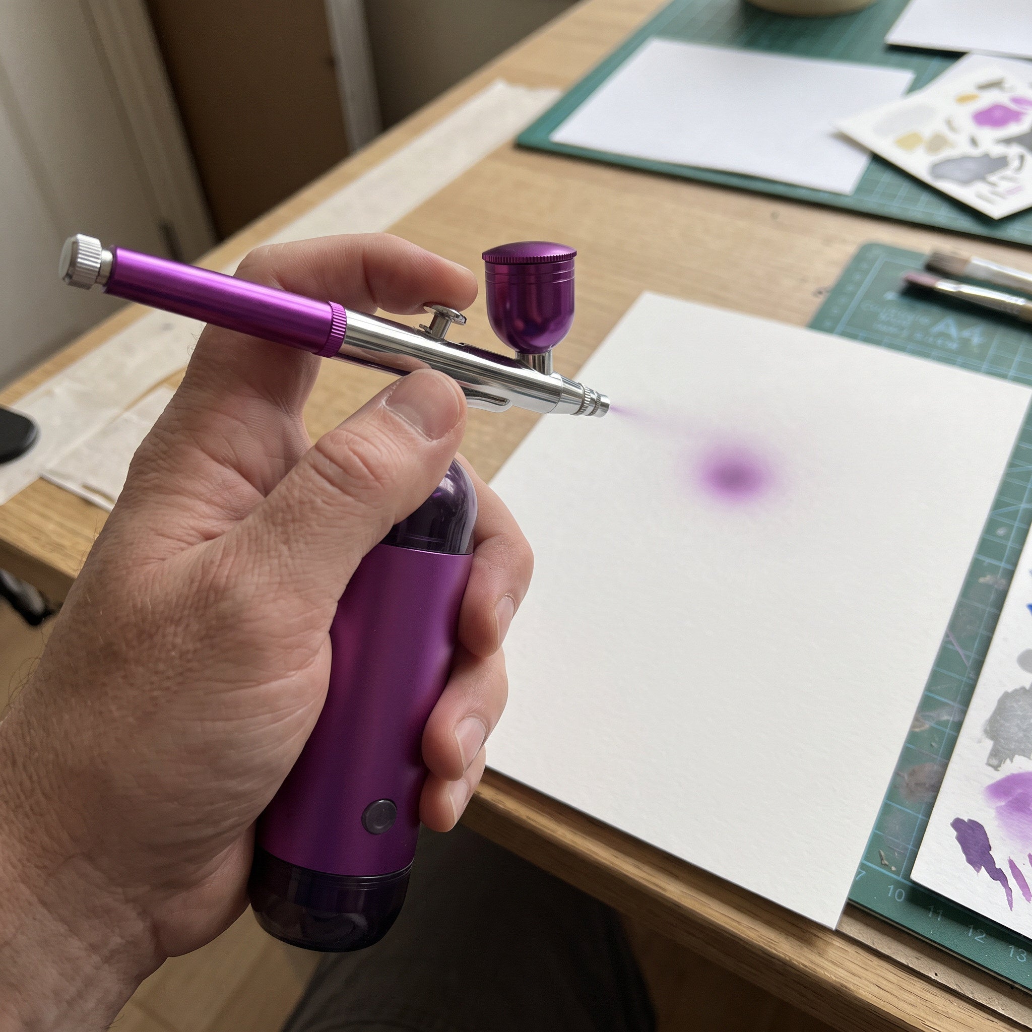 Airbrush Pointed At A Hobby Card
